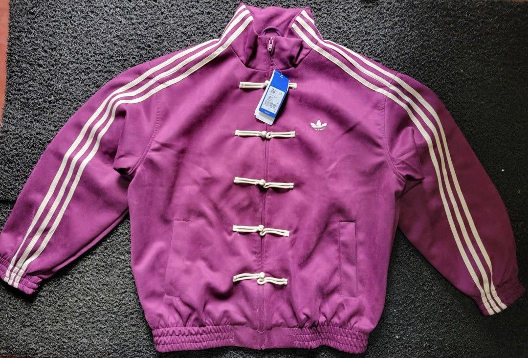 Adidas Track Jacket - Chinese Frog Button Style (Category: Coats, Jackets and Outerwear) located in Manila. Submitted by garahestorecollin (Listing ID 1462117671, Image 3). Description: - Classic Adidas track jacket - Unique Chinese frog button closure - Available colors: Red, Green, Purple - Ideal for retro and streetwear fashion - Stand out with this distinctive piece.