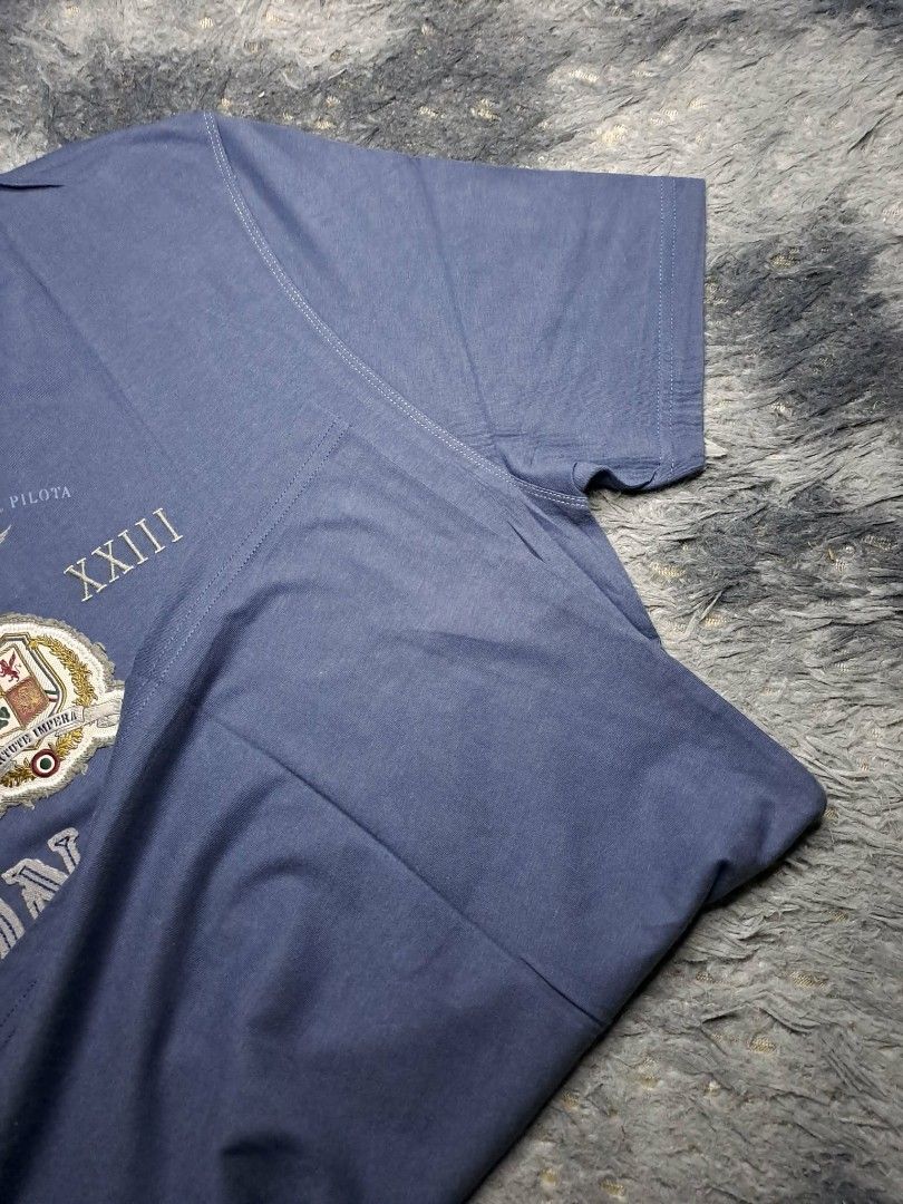 Aeronautica Militare (Category: Tshirts & Polo Shirts ) located in Manila. Submitted by yaseen__73 (Listing ID 1462204704, Image 2). Description: Aeronautica Militare crew-neck T-shirt in navy blue. It features stylized graphics inspired by the Italian Air Force, including military emblems, Roman numerals, and aviation text overlays. Wearing Size : M - L Dimensions : See Photo Color Rate : 10/10 Flawless Brand New Condition - P R E O W N E D MOP 