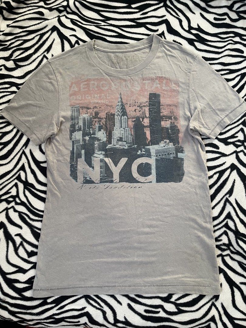 Aeropostale graphic t-shirt (Category: Tshirts & Polo Shirts ) located in Santo Tomas. Submitted by venpineda (Listing ID 1462123406, Image 1). Description: This appears to be a grey Aeropostale graphic t-shirt featuring a faded New York City skyline print with the Chrysler Building and bold “NYC” lettering. single stitching size Xs Length 26 width 17.