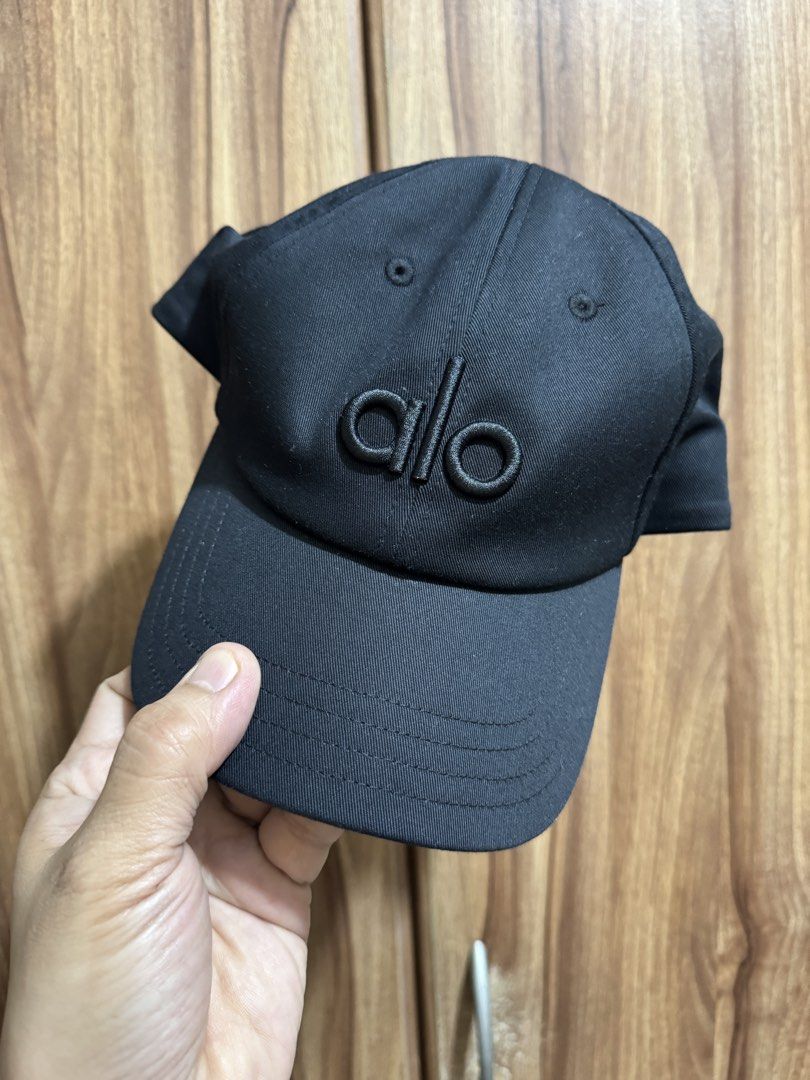 Alo Black Baseball Cap (Category: Caps & Hats) located in Manila. Submitted by schumacher14 (Listing ID 1462038552, Image 1). Description: - Classic black Alo cap - Features embroidered Alo logo on the front - Comes with original Alo shopping bag - Adjustable strap at the back for a comfortable fit - Ideal for everyday wear or workouts.