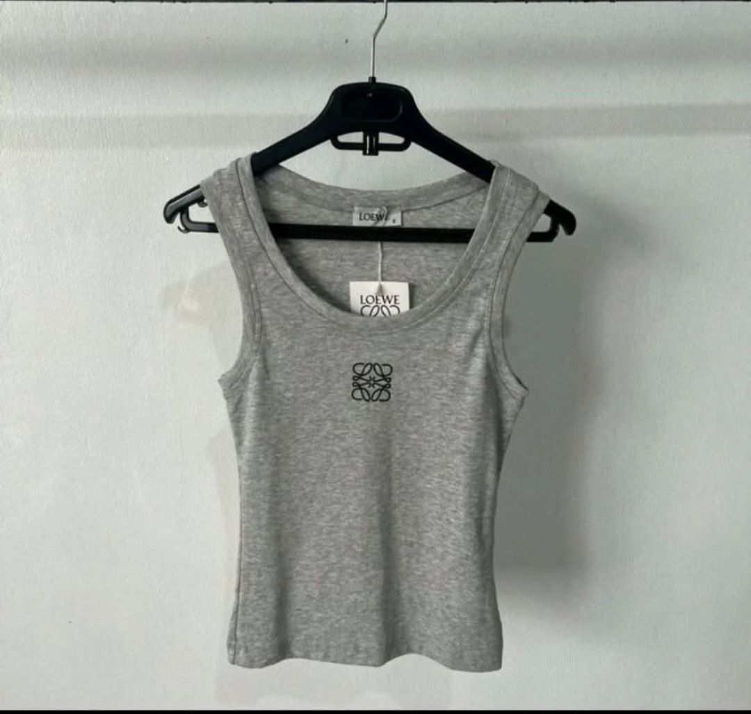 Anagram Tank Top - Grey & Cream (Category: Sleeveless) located in Manila. Submitted by katkween23 (Listing ID 1462049739, Image 1). Description: - Classic Loewe tank tops - Features iconic Anagram logo - Comfortable ribbed knit fabric - Available in grey and cream - Versatile for layering or wearing on its own.