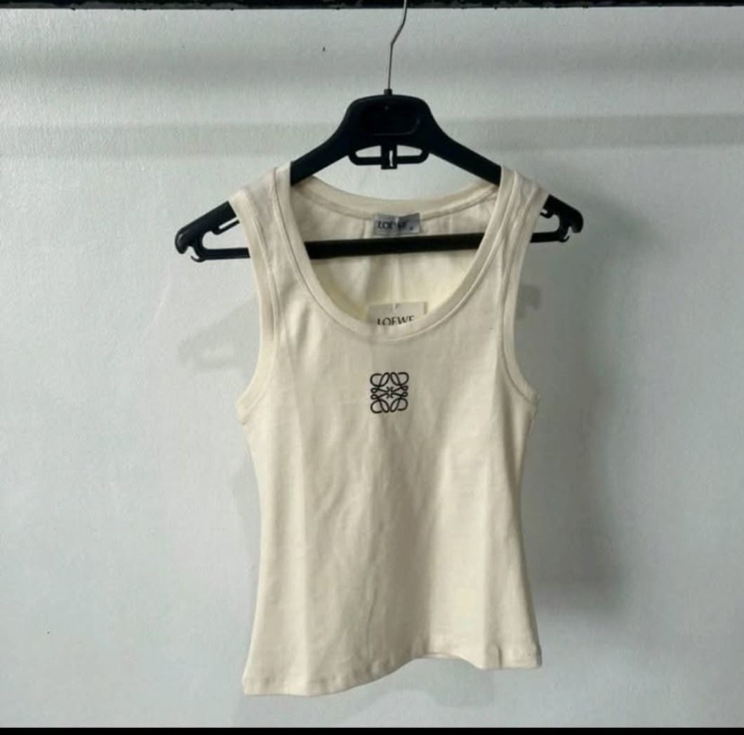 Anagram Tank Top - Grey & Cream (Category: Sleeveless) located in Manila. Submitted by katkween23 (Listing ID 1462049739, Image 2). Description: - Classic Loewe tank tops - Features iconic Anagram logo - Comfortable ribbed knit fabric - Available in grey and cream - Versatile for layering or wearing on its own.