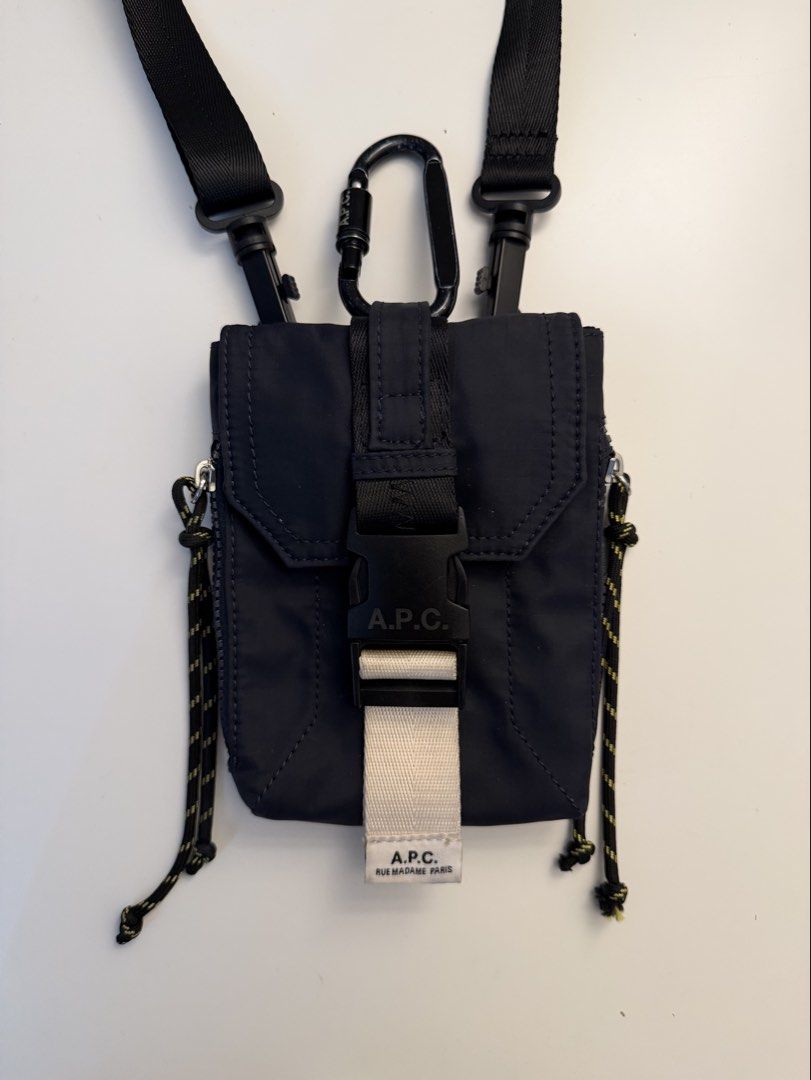 A.P.C. Trek messenger bag (Category: Cross-body Bags) located in Manila. Submitted by jeonjungoo (Listing ID 1462180837, Image 2). Description: still in great condition! barely used, except for the carabiner which i used for my keys lol - Navy blue A.P.C. crossbody bag - Durable nylon material - Secure buckle closure - Adjustable straps for comfort - Back pocket with fields for name, address, phone, and email - Includes a carabiner clip - Ideal f