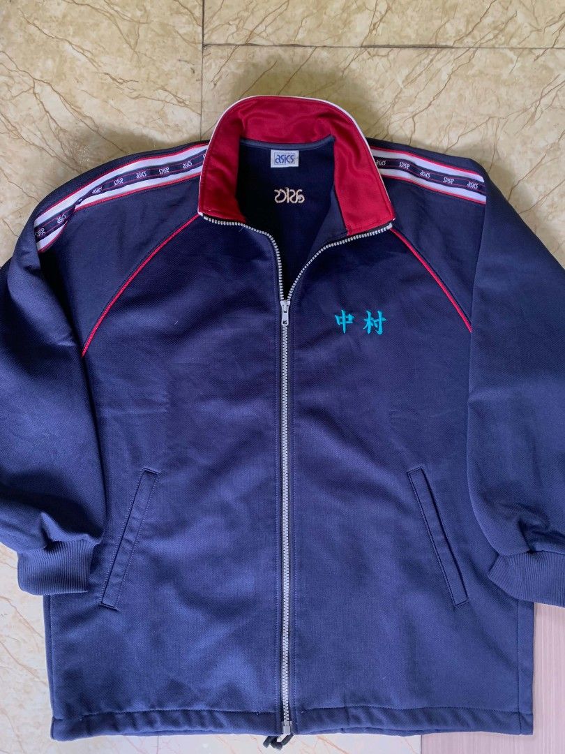Asics Navy Blue Track Jacket with Red Trim (Category: Coats, Jackets and Outerwear) located in Quezon City. Submitted by chic.on.a.dime (Listing ID 1462067069, Image 1). Description: - NO ISSUE - Navy blue Asics track jacket - Red trim on collar and sleeves - Embroidered Japanese character on chest - Asics logo on back - Ribbed cuffs and collar - Zipper closure - Large to XL size NOTE: MANAGE YOUR EXPECTATIONS ‼️📢 - color may vary due to lightin