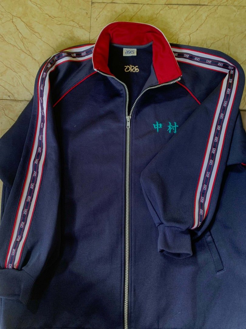 Asics Navy Blue Track Jacket with Red Trim (Category: Coats, Jackets and Outerwear) located in Quezon City. Submitted by chic.on.a.dime (Listing ID 1462067069, Image 2). Description: - NO ISSUE - Navy blue Asics track jacket - Red trim on collar and sleeves - Embroidered Japanese character on chest - Asics logo on back - Ribbed cuffs and collar - Zipper closure - Large to XL size NOTE: MANAGE YOUR EXPECTATIONS ‼️📢 - color may vary due to lightin