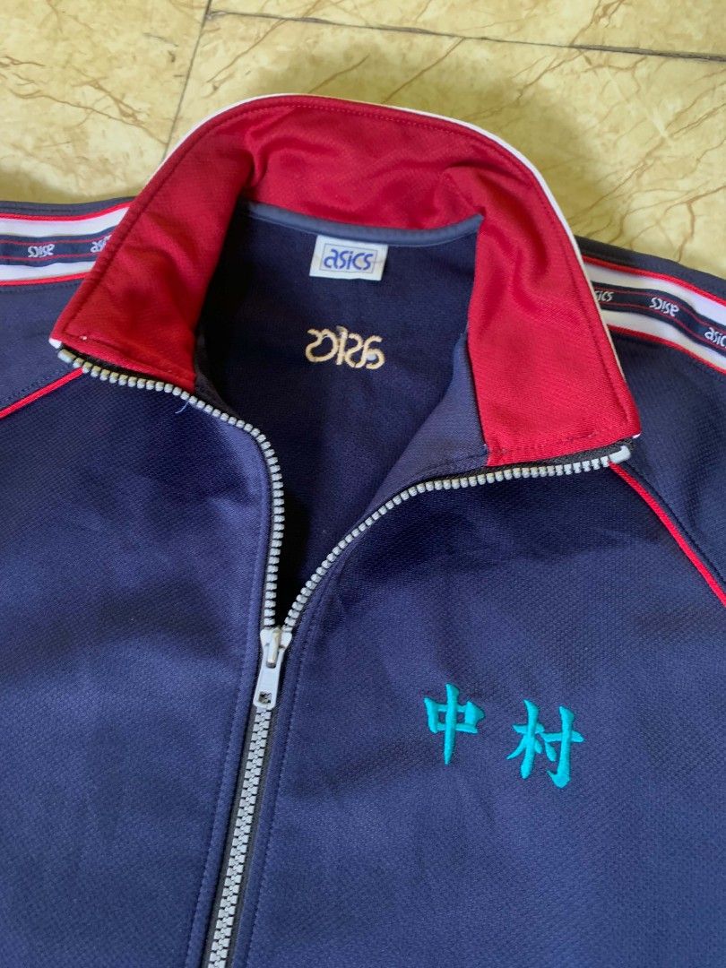 Asics Navy Blue Track Jacket with Red Trim (Category: Coats, Jackets and Outerwear) located in Quezon City. Submitted by chic.on.a.dime (Listing ID 1462067069, Image 3). Description: - NO ISSUE - Navy blue Asics track jacket - Red trim on collar and sleeves - Embroidered Japanese character on chest - Asics logo on back - Ribbed cuffs and collar - Zipper closure - Large to XL size NOTE: MANAGE YOUR EXPECTATIONS ‼️📢 - color may vary due to lightin