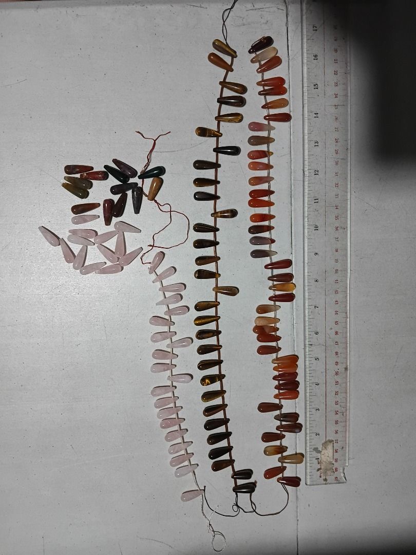 Assorted Gemstone Teardrop Beads for Jewelry Making (Category: Craft Supplies & Tools) located in Marikina City. Submitted by my-an (Listing ID 1462201500, Image 3). Description: - Assorted elongated teardrop-shaped natural stone beads - Includes Rose Quartz, Tiger's Eye, Carnelian, and possibly Agate/Jasper - Perfect for DIY necklaces, bracelets, and earrings - Strung on thread for convenient handling - Ruler included in photos for size referenc