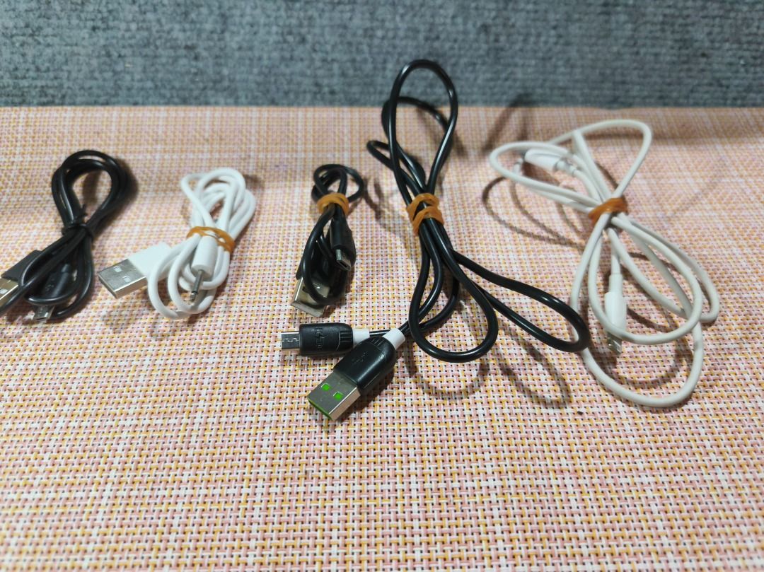 Assorted USB Charging & Audio Cable Bundle (5-Piece Lot) (Category: Chargers & Cables) located in San Leonardo. Submitted by burgossanleonardo.12345 (Listing ID 1462191226, Image 1). Description: Description:Selling a bundle of 5 useful electronic cables in good condition. Great to keep as spares for your home, car, or office!The lot includes:2x Standard Micro-USB Cables (Black)1x Dual-Split Micro-USB Charging Cable (Black)1x Apple iPhone Lightni