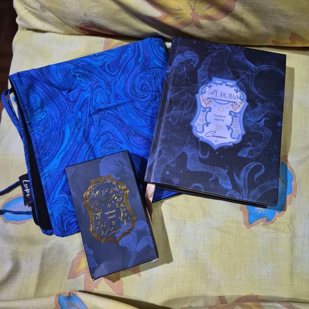 Aurora Tarot Deck by Coccorina (Category: Board Games & Puzzles) located in Quezon City. Submitted by thesirenscavern (Listing ID 1462076380, Image 1). Description: Bought from Kickstarter. Has gold gilding. Includes guidebook, box, and tarot wrap. ⚠️ Payment first before shipping⚠️ MOP: BDO, BPI, Metrobank, GCash, CIMB.