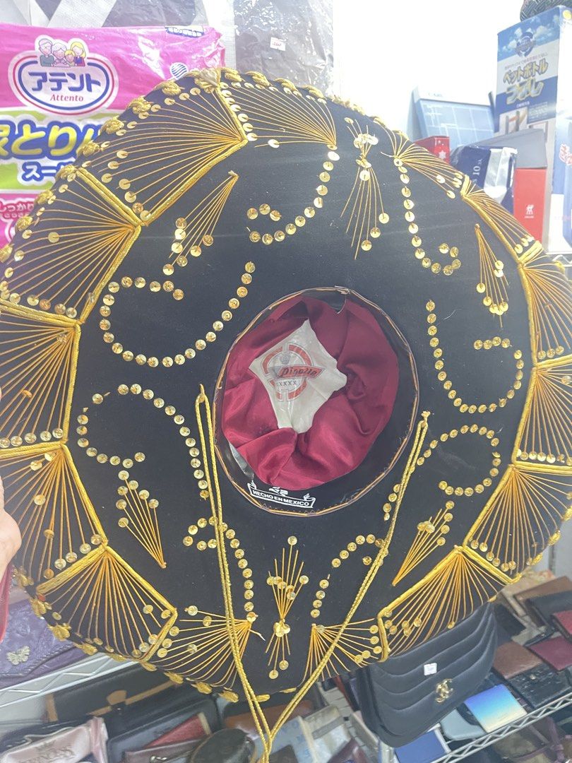 Authentic "Hecho en Mexico" Mariachi Sombrero Hat (Category: Caps & Hats) located in Marilao. Submitted by wardrovearchives (Listing ID 1462138930, Image 2). Description: - Authentic Mexican Sombrero Hat - Features intricate gold embroidery and sparkling sequins - Lined with luxurious red satin - Ideal for parties, costume events, or as a unique decorative piece - Eye-catching and one-of-a-kind design.