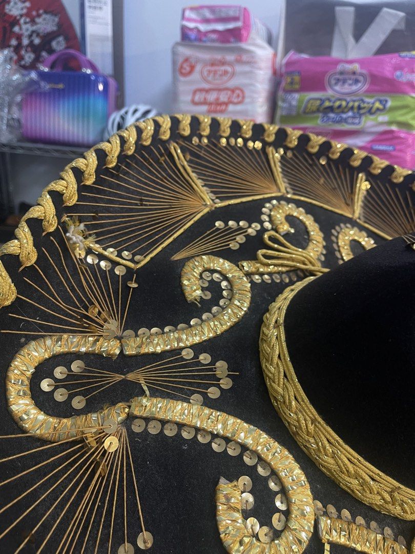 Authentic "Hecho en Mexico" Mariachi Sombrero Hat (Category: Caps & Hats) located in Marilao. Submitted by wardrovearchives (Listing ID 1462138930, Image 1). Description: - Authentic Mexican Sombrero Hat - Features intricate gold embroidery and sparkling sequins - Lined with luxurious red satin - Ideal for parties, costume events, or as a unique decorative piece - Eye-catching and one-of-a-kind design.
