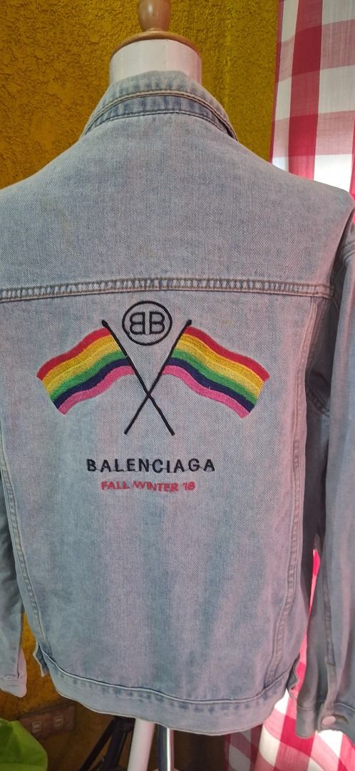 Balenciaga 2018 Denim Jacket Rainbow Flags (Category: Luxury Apparel) located in Manila. Submitted by katkween23 (Listing ID 1462062315, Image 2). Description: - Balenciaga Denim Jacket - Fall Winter 2018 Collection - Features embroidered rainbow flags and BB logo on the back - Classic light wash denim - Button closure and chest pockets - Size: L.