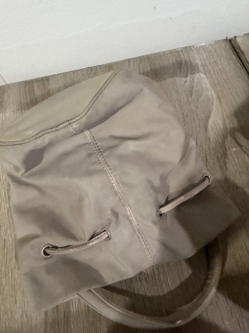 Balenciaga Bucket Bag (Category: Luxury Bags & Wallets) located in Paranaque City. Submitted by kaina1849240 (Listing ID 1462215207, Image 2). Description: - Balenciaga bucket bag - Neutral beige color - Drawstring closure - Two top handles - Dark interior - Signs of wear on exterior and handles (please check photos for details).