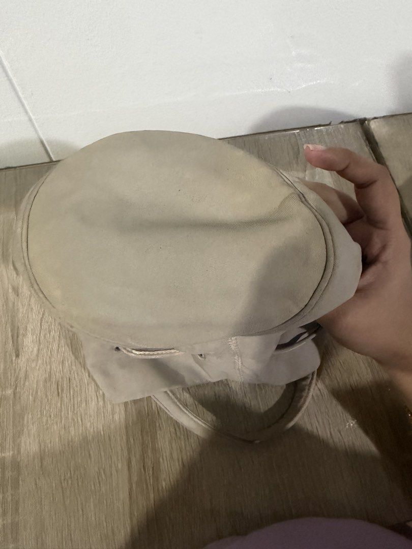 Balenciaga Bucket Bag (Category: Luxury Bags & Wallets) located in Paranaque City. Submitted by kaina1849240 (Listing ID 1462215207, Image 3). Description: - Balenciaga bucket bag - Neutral beige color - Drawstring closure - Two top handles - Dark interior - Signs of wear on exterior and handles (please check photos for details).