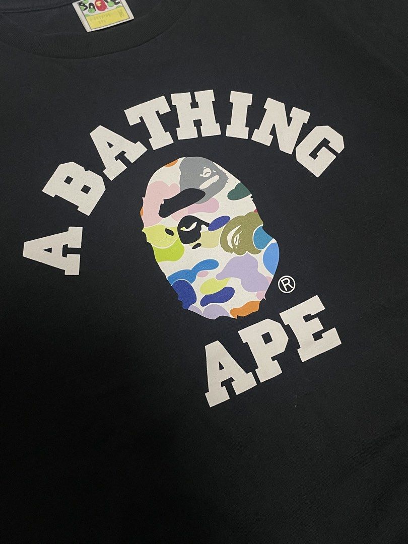 BAPE College Multi Colored Camo tshirt (Category: Activewear) located in Caloocan City. Submitted by thriftkidd2024 (Listing ID 1462163018, Image 2). Description: [ BAPE College Multi Colored Camo ] M on tag width: 21 length:26.5 In Excellent condition 9/10 color rate No issue ₱2,500 Taguig city📍 Dm to purchase 📥.