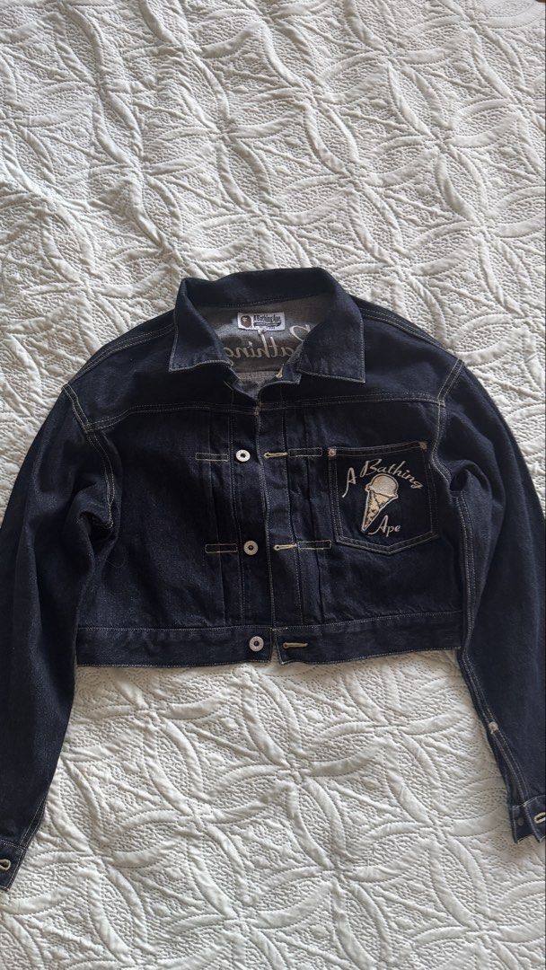 BAPE Denim Jacket Ice Cream Patch (Category: Coats, Jackets and Outerwear) located in Paranaque City. Submitted by sierraah (Listing ID 1462220244, Image 1). Description: - Brand: A Bathing Ape (BAPE) - Style: Blue Denim Jacket - Size: XS on tag -Bought in: Osaka, Japan -Never been used/worn - Features: Embroidered ice cream cone and logo on chest pocket - Back Detail: "A Bathing Ape" embroidery across the back - Closure: Button front and button 