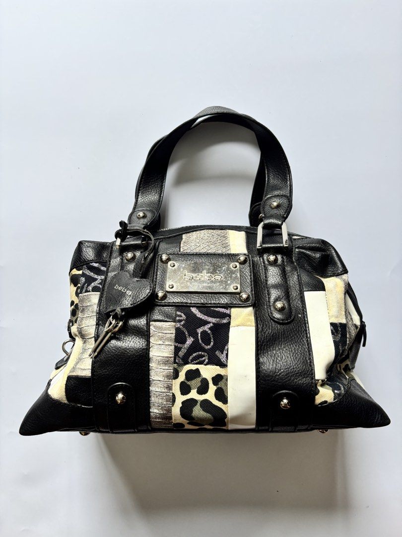 Bebe Patchwork Leather & Fabric Handbag (Category: Tote Bags) located in Manila. Submitted by anik.anik_ph (Listing ID 1462089456, Image 1). Description: - Unique patchwork design: Mix of black leather and patterned fabric. - Adorable heart-shaped tag with a key charm. - Convenient top handles for easy carrying. - Secure zip closure to keep your belongings safe. - Spacious interior, ideal for everyday essentials. - Stylish and practical for daily