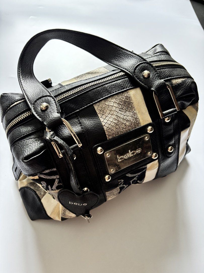 Bebe Patchwork Leather & Fabric Handbag (Category: Tote Bags) located in Manila. Submitted by anik.anik_ph (Listing ID 1462089456, Image 2). Description: - Unique patchwork design: Mix of black leather and patterned fabric. - Adorable heart-shaped tag with a key charm. - Convenient top handles for easy carrying. - Secure zip closure to keep your belongings safe. - Spacious interior, ideal for everyday essentials. - Stylish and practical for daily