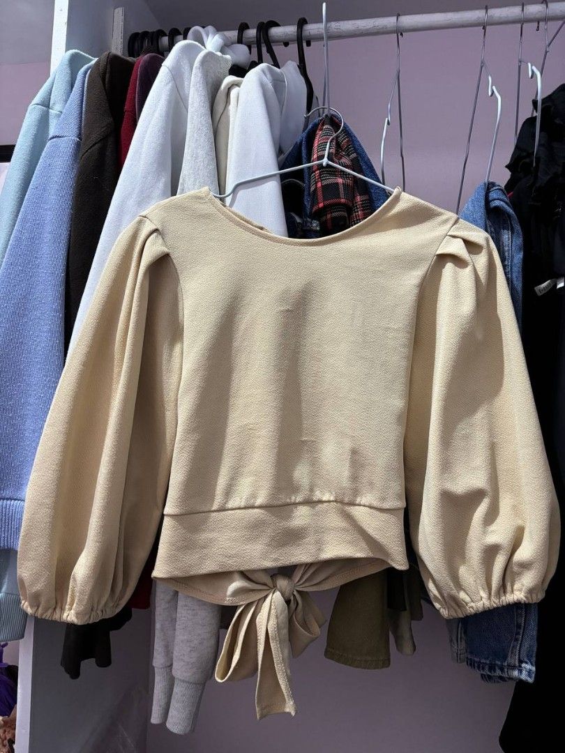 Beige Open-back Top (Category: Blouses) located in Quezon City. Submitted by declutteringnook (Listing ID 1462084535, Image 2). Description: - fits xs to small - with puff sleeves and tie details - fabric is french terry, parang lighter fleece ganun - see pic for when worn - only used once - loc: QC near Fishermall.