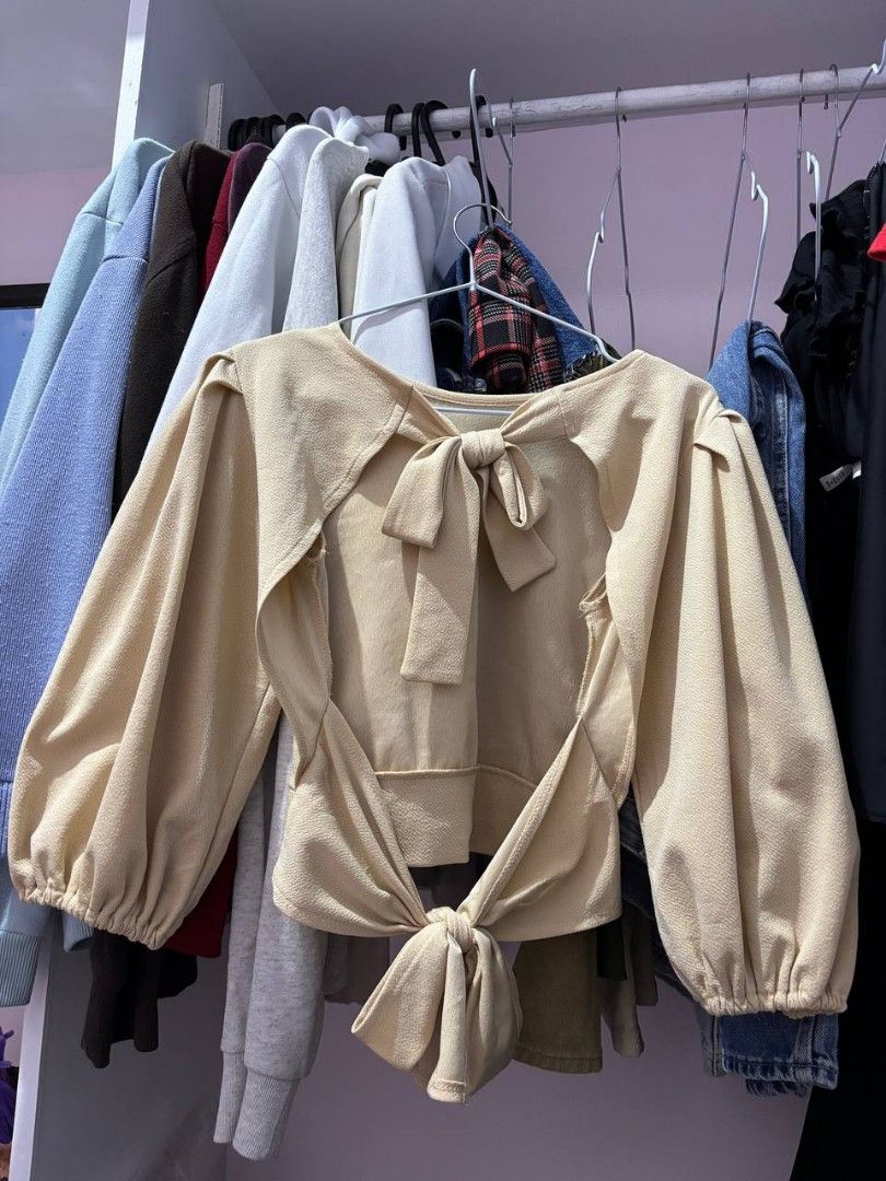 Beige Open-back Top (Category: Blouses) located in Quezon City. Submitted by declutteringnook (Listing ID 1462084535, Image 3). Description: - fits xs to small - with puff sleeves and tie details - fabric is french terry, parang lighter fleece ganun - see pic for when worn - only used once - loc: QC near Fishermall.