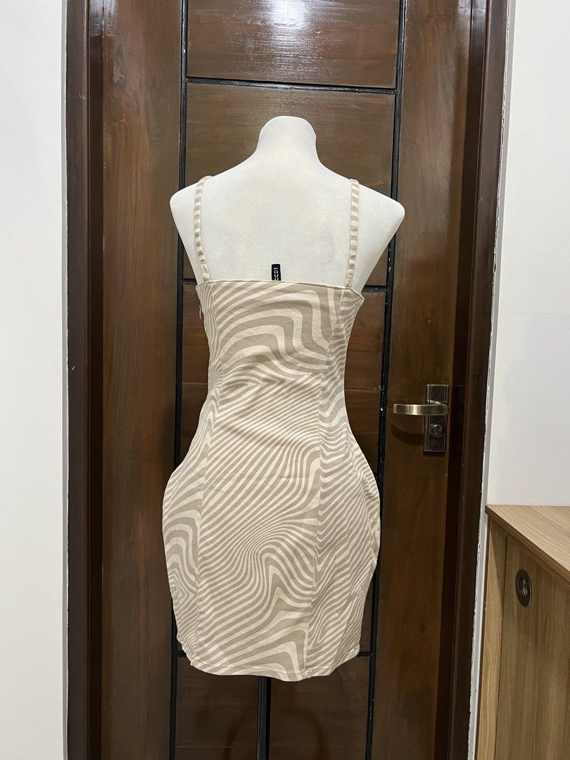 Beige Zebra Print Mini Dress (Category: Dresses) located in Angat. Submitted by yanacruise (Listing ID 1462052285, Image 2). Description: - Cute beige mini dress - Bold zebra print - Spaghetti straps - Bodycon fit - Perfect for night out or casual day - Versatile styling with heels or sneakers.