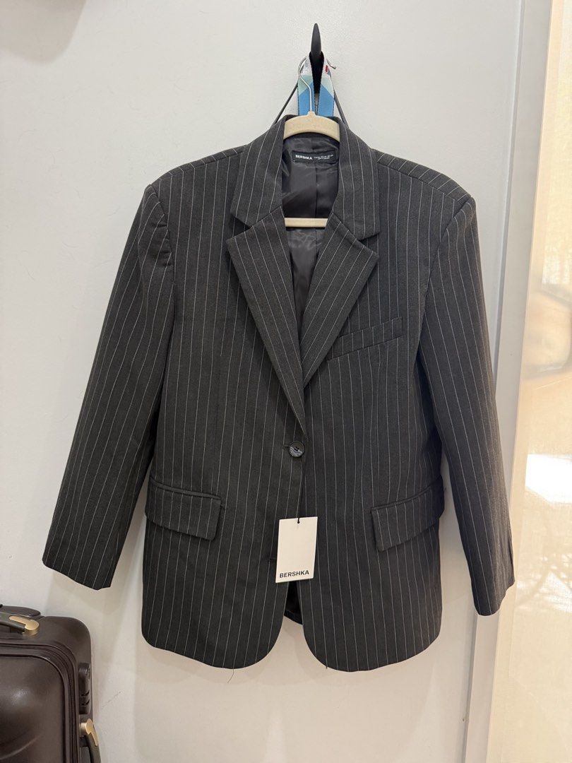 Bershka Pinstripe Blazer (Category: Coats, Jackets and Outerwear) located in Angeles City. Submitted by adeclutters__ (Listing ID 1462094345, Image 1). Description: - Dark grey blazer with white pinstripes - Single button front closure - Two side flap pockets - Fully lined interior - Original tags appear to be attached - Perfect for both formal and casual wear Bought at 3795 Selling at 1800.