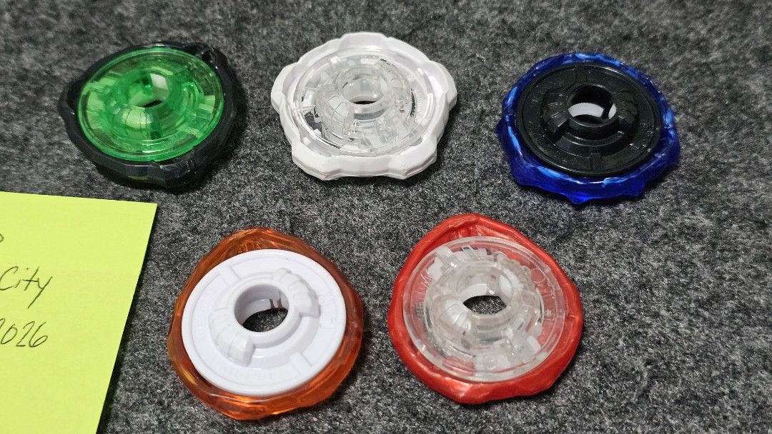 Beyblade X Parts (Category: Action & Battle Toys) located in Manila. Submitted by greycrane (Listing ID 1462168172, Image 3). Description: Beyblade X Parts Bits - sold as set only 800 Rush - 6/10 with chip Low Rush - 5/10 well-used Hexa - 7/10 Free Ball - 8.5/10 Level - 8/10 Wedge - 8/10 Ratchets - sold as set only for 800 1-60 - 8/10 1-70 - 8/10 3-60 - 8/10 5-60 - 7.5/10 9-60 - 7/10 TT Wizard Rod 35.68g 7/10 for 600 TT Shark Scale 37.58g 7/10 fo