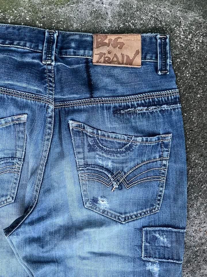 Big Train Osaka Jeans Distressed Patchwork Denim (Category: Jeans) located in Maasim. Submitted by ukayganda25 (Listing ID 1462118615, Image 3). Description: - Cool Big Train jeans - Distressed patchwork design - Classic blue wash - Unique details on front and back pockets - Button fly closure - Straight leg fit - Perfect for a casual, stylish look - A true statement piece.
