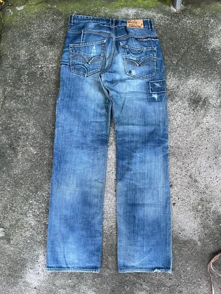 Big Train Osaka Jeans Distressed Patchwork Denim (Category: Jeans) located in Maasim. Submitted by ukayganda25 (Listing ID 1462118615, Image 2). Description: - Cool Big Train jeans - Distressed patchwork design - Classic blue wash - Unique details on front and back pockets - Button fly closure - Straight leg fit - Perfect for a casual, stylish look - A true statement piece.