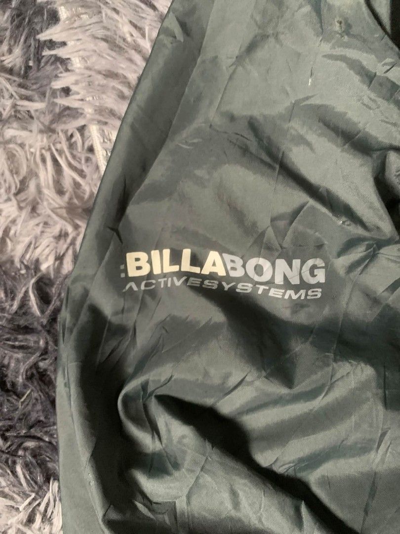 Billabong Active Systems Windbreaker Jacket (Category: Coats, Jackets and Outerwear) located in Tarlac. Submitted by rhandell_collectives (Listing ID 1462046126, Image 2). Description: - Billabong windbreaker jacket - Color: Dark Green - Size: L - Lightweight and packable design - Full zip front with hood - Billabong Active Systems logo on sleeve and chest - Ideal for outdoor activities and casual wear.