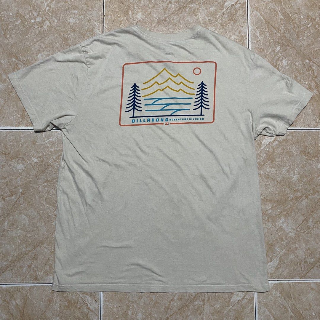 Billabong Adventure Division Tee (Category: Activewear) located in Manila. Submitted by killthismane (Listing ID 1462138183, Image 3). Description: A cream-colored Billabong Adventure Division short-sleeve t-shirt featuring a mountain, ocean, and tree graphic on the back..