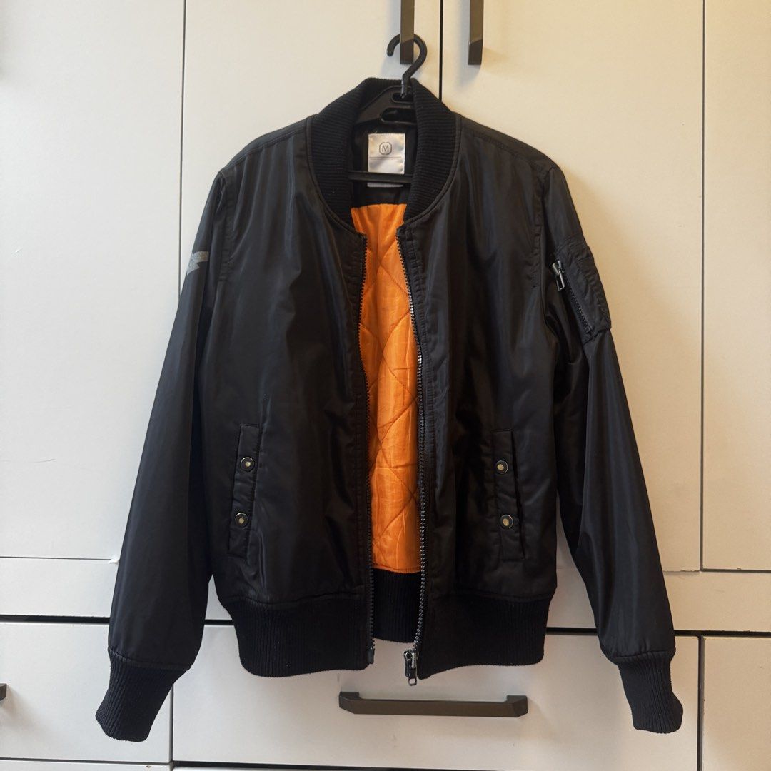 Black Bomber Jacket with Orange Lining (Category: Coats, Jackets and Outerwear) located in Quezon City. Submitted by closet.aid (Listing ID 1462113932, Image 1). Description: - Classic black bomber jacket - Bright orange quilted lining - Ribbed collar, cuffs, and hem - Zipper closure - Front pockets - Zippered pocket on sleeve.