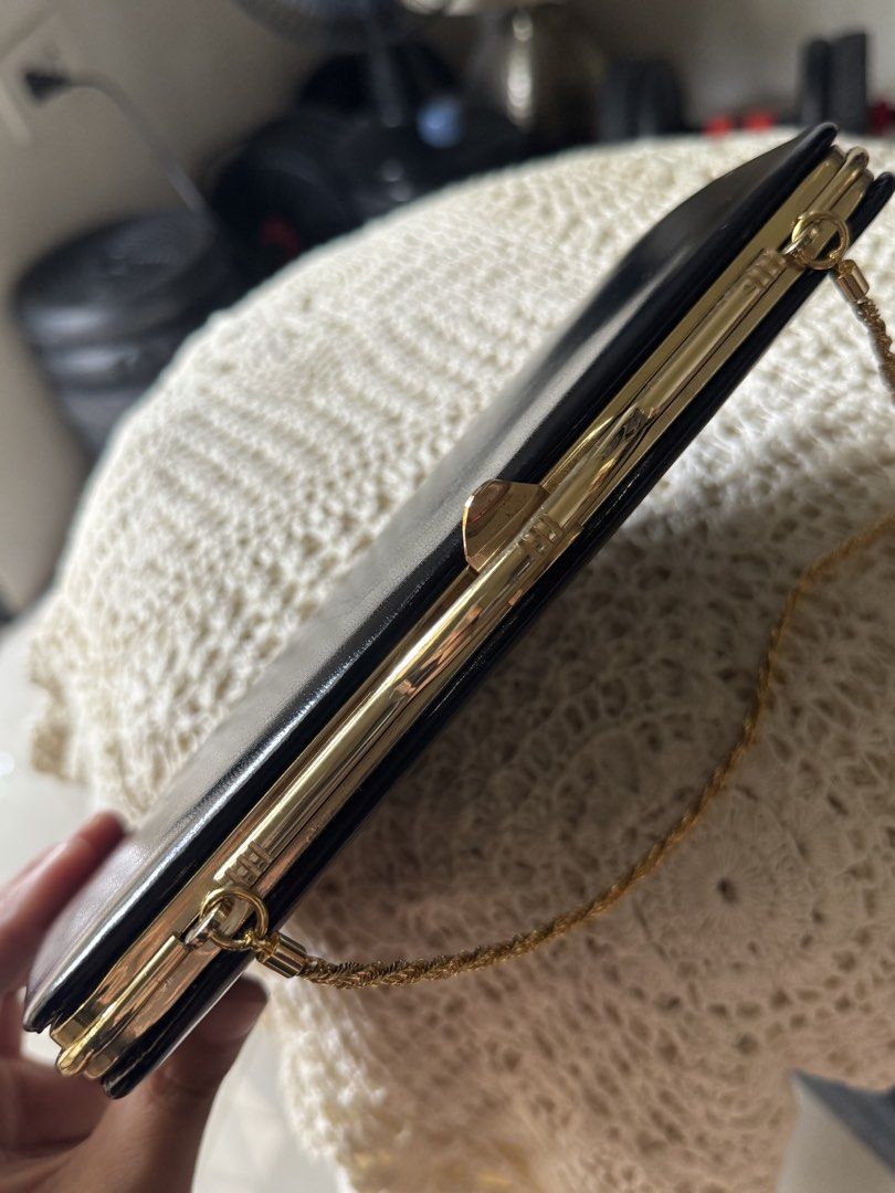 Black clutch bag with gold chain (Category: Clutches) located in Bacolod City. Submitted by vintage_vogue6100 (Listing ID 1462139309, Image 3). Description: - Classic black clutch bag - Thin gold chain strap included - Interior with multiple compartments - Secure clasp closure - Ideal for evening wear and special occasions - Simple and chic design.