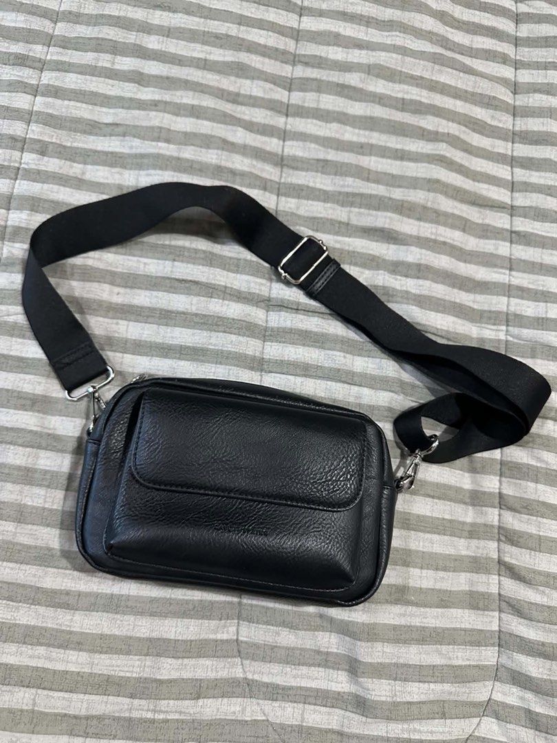 Black Leather Crossbody Bag with Adjustable Strap (Category: Sling Bags) located in Manila. Submitted by vingoodies (Listing ID 1462103493, Image 1). Description: - Stylish black crossbody bag - Made from durable faux leather - Main compartment for essentials - Convenient front pocket with flap closure - Adjustable strap for crossbody or shoulder wear - Elegant silver-tone hardware - Simple and versatile design for any outfit 500 each po 800 pag 