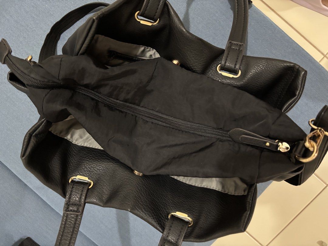Black Leather Tote Bag (Category: Shoulder Bags) located in Pasig City. Submitted by sarpaz (Listing ID 1462073107, Image 3). Description: - Brand: CureBorsa - Material: Black Leather - Features: Top handles, detachable shoulder strap - Hardware: Gold details (bottom studs, strap attachments) - Interior: Zippered compartment, spacious main compartment - Ideal for: Everyday use Bought in JAPAN.