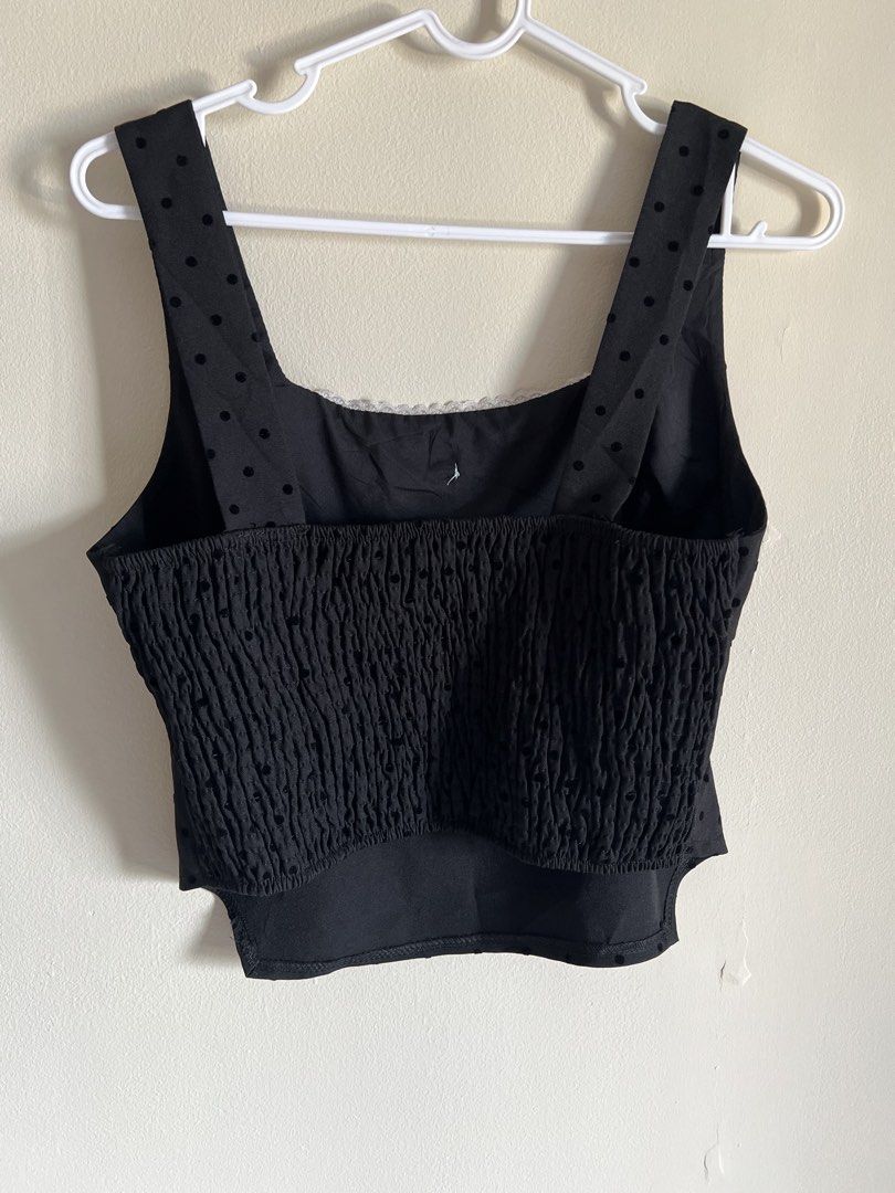 Black Polka Dot Square Neck Crop Top with Smocked Back (Category: Sleeveless) located in Manila. Submitted by francinemanaois (Listing ID 1462072216, Image 2). Description: - Cute black crop top - Square neckline - Subtle polka dot pattern - Small white bow detail at the front - Smocked back for a comfortable fit - Versatile for casual outings or nights out.