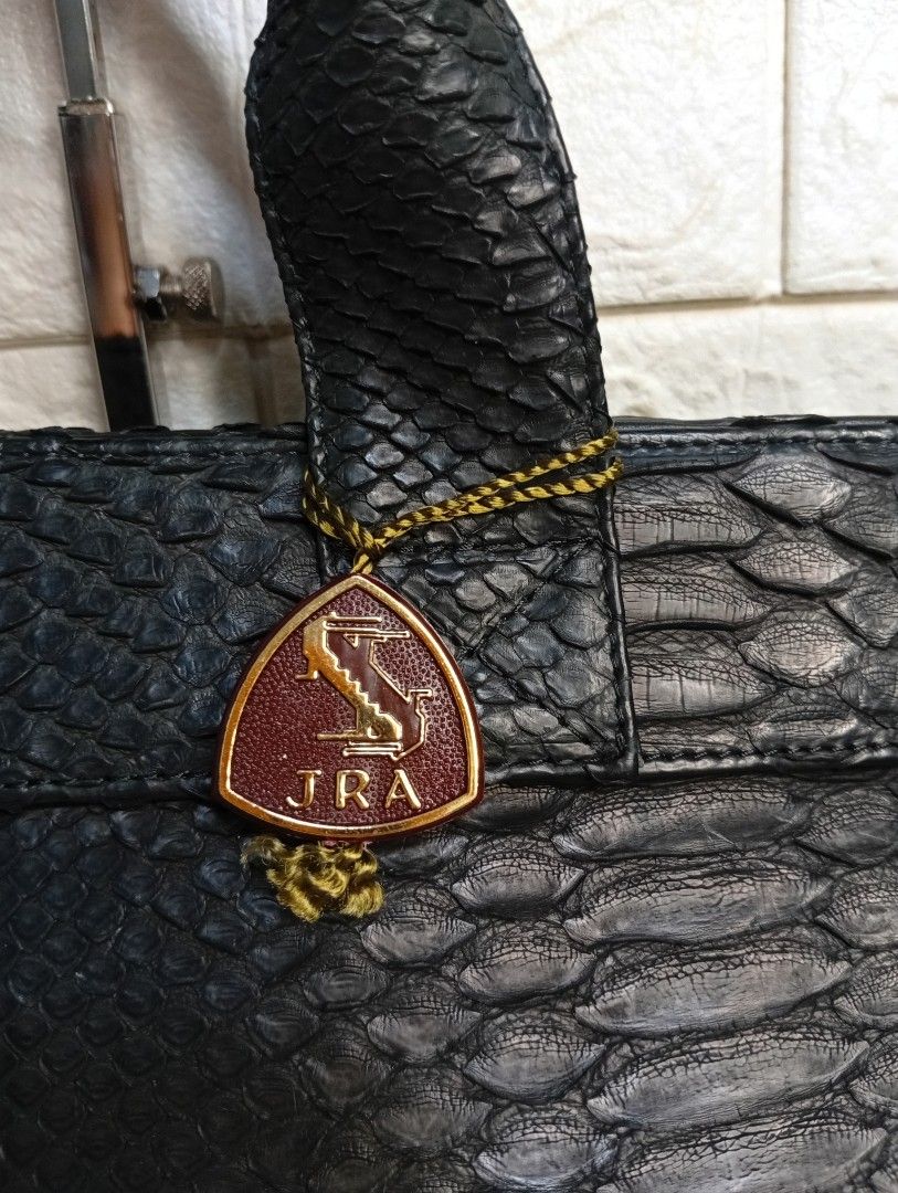 Black Python Leather Handbag with JRA Charm (Category: Tote Bags) located in Las Pinas. Submitted by etoksi1234 (Listing ID 1462126501, Image 3). Description: Pre-loved JRA black exotic leather handbag with double top handles and gold-tone turn-lock hardware, featuring a small triangular JRA (Japan Reptile Leather Industries Association) charm tag attached to the front. NO sling included..