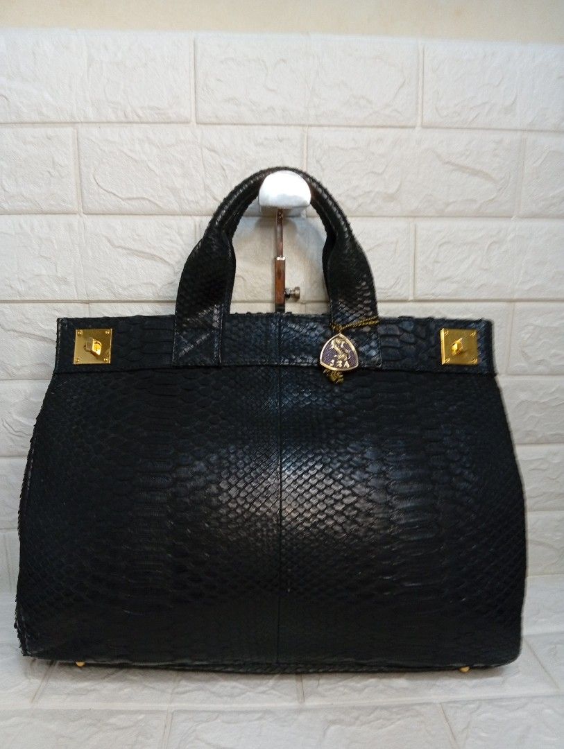 Black Python Leather Handbag with JRA Charm (Category: Tote Bags) located in Las Pinas. Submitted by etoksi1234 (Listing ID 1462126501, Image 1). Description: Pre-loved JRA black exotic leather handbag with double top handles and gold-tone turn-lock hardware, featuring a small triangular JRA (Japan Reptile Leather Industries Association) charm tag attached to the front. NO sling included..
