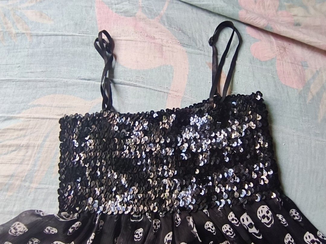 black skull sequinned dress. (Category: Dresses) located in Manila. Submitted by avwilynn (Listing ID 1462056161, Image 2). Description: *Black Skull Sequin Babydoll Dress* Edgy Y2K party dress - super cute for Halloween, concerts, or going out! *Details:* - *Top:* Fully sequinned / glittery bust in black/silver, stretchy smocked back for comfy fit - *Bottom:* Sheer chiffon flowy skirt with all-over white skull print - giving Alexander McQueen / 