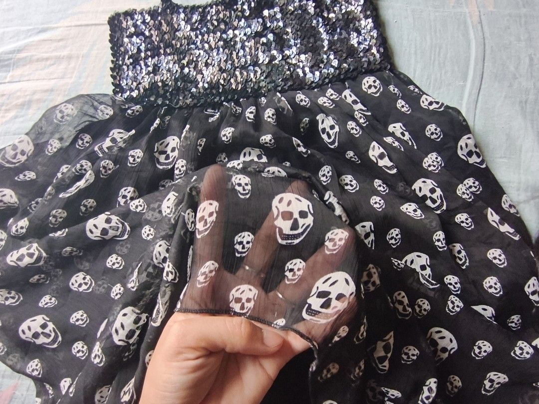 black skull sequinned dress. (Category: Dresses) located in Manila. Submitted by avwilynn (Listing ID 1462056161, Image 3). Description: *Black Skull Sequin Babydoll Dress* Edgy Y2K party dress - super cute for Halloween, concerts, or going out! *Details:* - *Top:* Fully sequinned / glittery bust in black/silver, stretchy smocked back for comfy fit - *Bottom:* Sheer chiffon flowy skirt with all-over white skull print - giving Alexander McQueen / 
