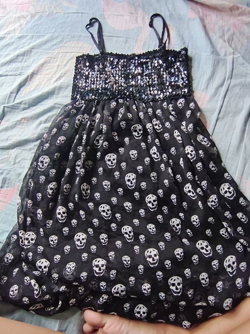 black skull sequinned dress. (Category: Dresses) located in Manila. Submitted by avwilynn (Listing ID 1462056161, Image 1). Description: *Black Skull Sequin Babydoll Dress* Edgy Y2K party dress - super cute for Halloween, concerts, or going out! *Details:* - *Top:* Fully sequinned / glittery bust in black/silver, stretchy smocked back for comfy fit - *Bottom:* Sheer chiffon flowy skirt with all-over white skull print - giving Alexander McQueen / 