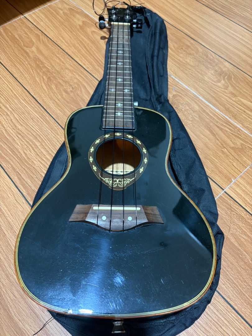 Black Concert Ukulele (Category: Musical Instruments) located in Quezon City. Submitted by lia.ho (Listing ID 1462179783, Image 2). Description: - Black concert ZI ukulele, 24" - Model number: LA03-24 (visible inside soundhole) - Comes with black travel bag - Fairly new nylon strings - Minor scratches and dents on body and headstock (see photos), but no issues at all with - Reason for selling: Decluttering Price negotiable, loc @ Bacoor area.