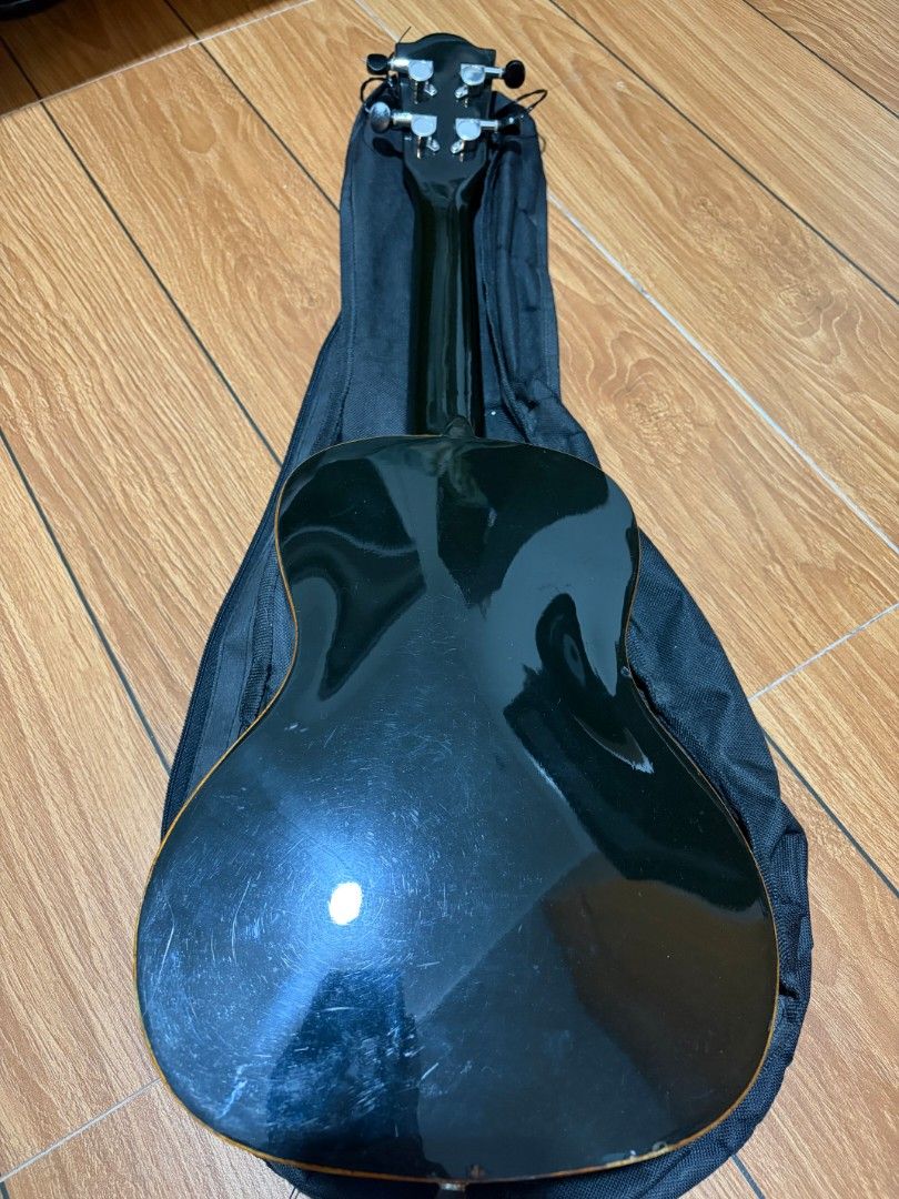 Black Concert Ukulele (Category: Musical Instruments) located in Quezon City. Submitted by lia.ho (Listing ID 1462179783, Image 3). Description: - Black concert ZI ukulele, 24" - Model number: LA03-24 (visible inside soundhole) - Comes with black travel bag - Fairly new nylon strings - Minor scratches and dents on body and headstock (see photos), but no issues at all with - Reason for selling: Decluttering Price negotiable, loc @ Bacoor area.