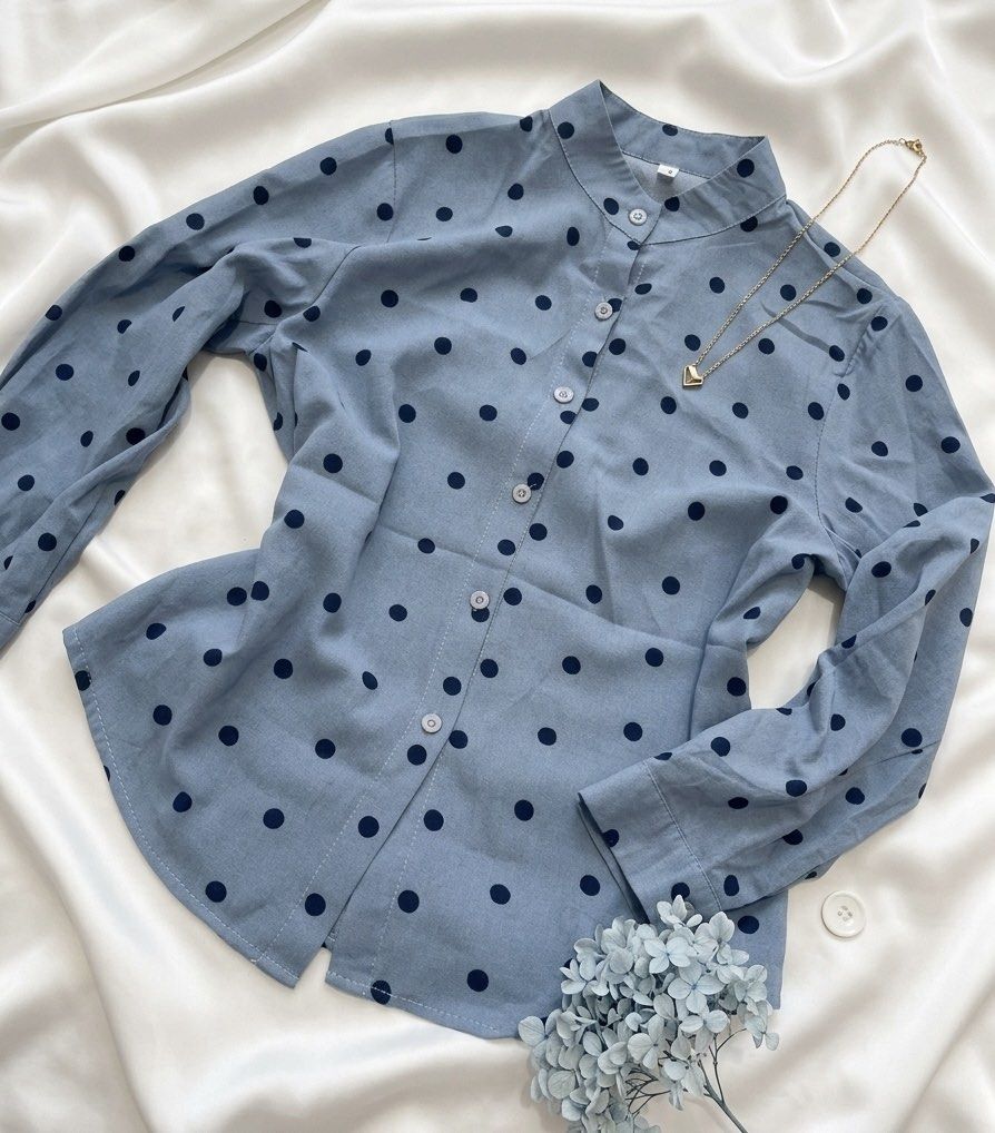 Blue Polka Dot Long Sleeve Button Up Shirt (Category: Blouses) located in Manila. Submitted by goldenprngs101 (Listing ID 1462168744, Image 1). Description: - Light blue shirt with navy blue polka dots - Band collar with button-up front - Long sleeves with button cuffs - Versatile for casual or dressy occasions - Pairs well with jeans or skirts #vintage #fashion #y2k #officeattire #formal #semiformal #casual #ootd #polkadots.