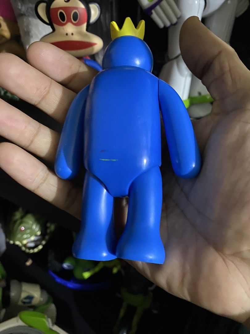 Blue Rainbow Friends Figure with Crown (Category: Figurines & Statues) located in Manila. Submitted by secretjoy.609 (Listing ID 1462094425, Image 3). Description: - Blue Rainbow Friends action figure - Features a yellow crown and a blue tongue sticking out - Shows minor scuffs on the body - Bottom marked 'Play & Church, LLC Mojo, LLC 2022 2307013' - Made in China - Ideal for fans of the game.