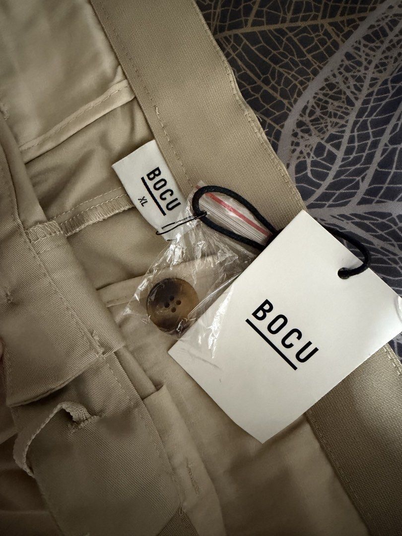 BOCU Beige Chinos Pants XL with Drawstring (Category: Chinos) located in Quezon City. Submitted by ashie17 (Listing ID 1462132117, Image 3). Description: - Brand: BOCU - Size: XL - Color: Beige - Style: Classic Chino - Features: Drawstring waist for comfort, front button closure, functional pockets - Condition: Brand new with original tags attached - Versatility: Ideal for casual outings or dressing up slightly.