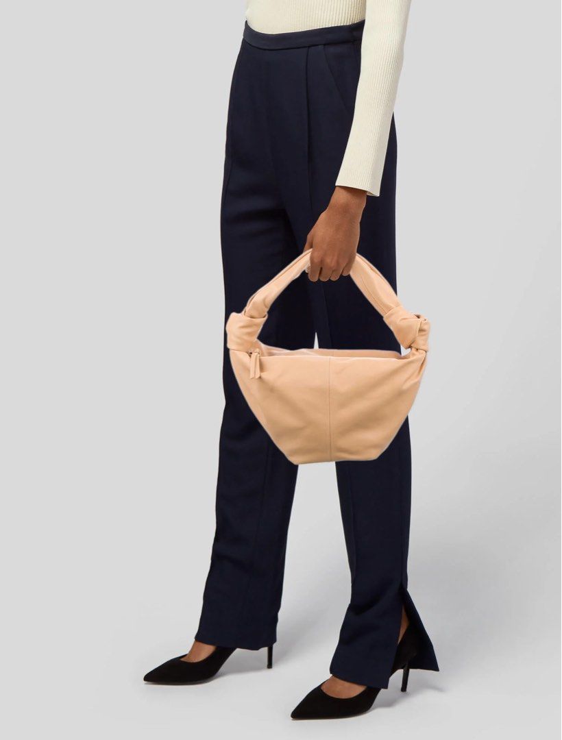 Bottega Veneta Double Tied (Category: Luxury Bags & Wallets) located in Batangas. Submitted by jereeemie (Listing ID 1462102186, Image 2). Description: BRANDNEW - Bottega Veneta Double tied bag 100 authentic with certificate of authenticity and dustbag only - Color: Nude/Peach - Material: Soft Leather - Features: Signature knotted handle, Zipper closure - Includes: Dust bag - Price: ₱52,000 (Reduced from ₱60,000)k.