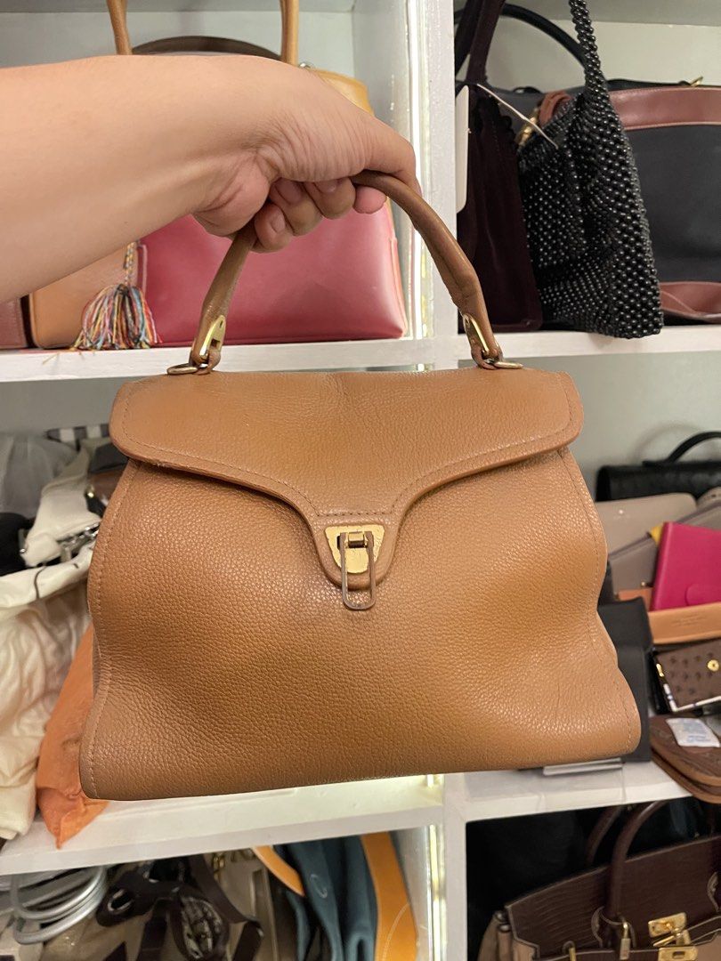 Brown Leather Top Handle Handbag (Category: Luxury Bags & Wallets) located in Marilao. Submitted by wardrovearchives (Listing ID 1462203880, Image 1). Description: - Classic brown leather handbag - Secure turn-lock closure - Sturdy top handle - Beautiful pebbled leather texture - Spacious interior for essentials - Versatile for everyday or dressing up.