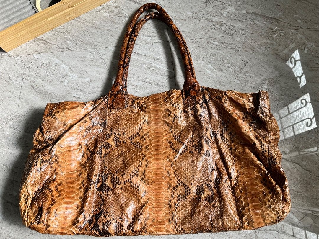 Brown Snakeskin Leather Tote Bag (Category: Tote Bags) located in Makati City. Submitted by Ina_Ndang (Listing ID 1462139414, Image 3). Description: - Spacious tote bag with a unique snakeskin pattern. - Ideal for everyday use or travel. - Ample interior space for all your essentials. - A statement piece to elevate any outfit. ~~~~~~~~~ - Approximate dimension: 19inches width, 11inches height, 9.5inches bag handles - No flaws, preloved - Payment 
