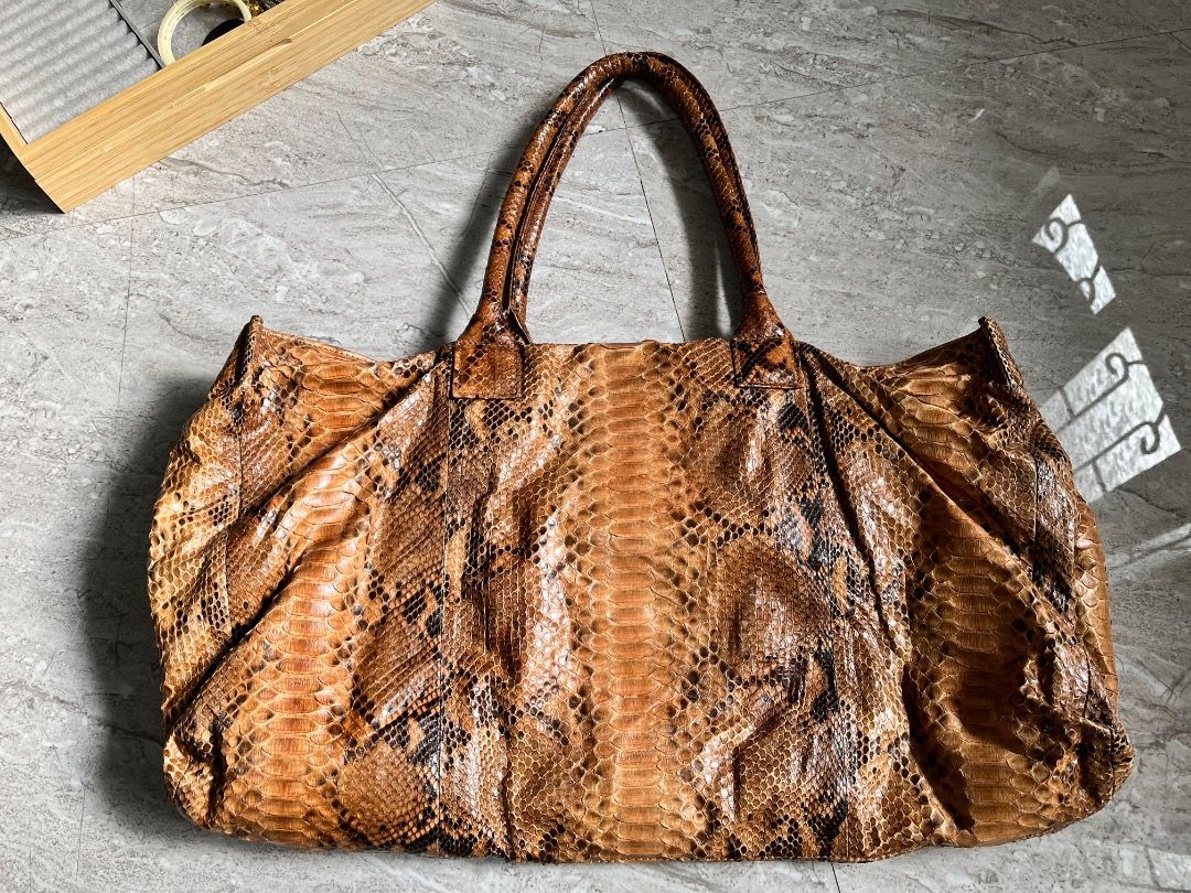 Brown Snakeskin Leather Tote Bag (Category: Tote Bags) located in Makati City. Submitted by Ina_Ndang (Listing ID 1462139414, Image 2). Description: - Spacious tote bag with a unique snakeskin pattern. - Ideal for everyday use or travel. - Ample interior space for all your essentials. - A statement piece to elevate any outfit. ~~~~~~~~~ - Approximate dimension: 19inches width, 11inches height, 9.5inches bag handles - No flaws, preloved - Payment 